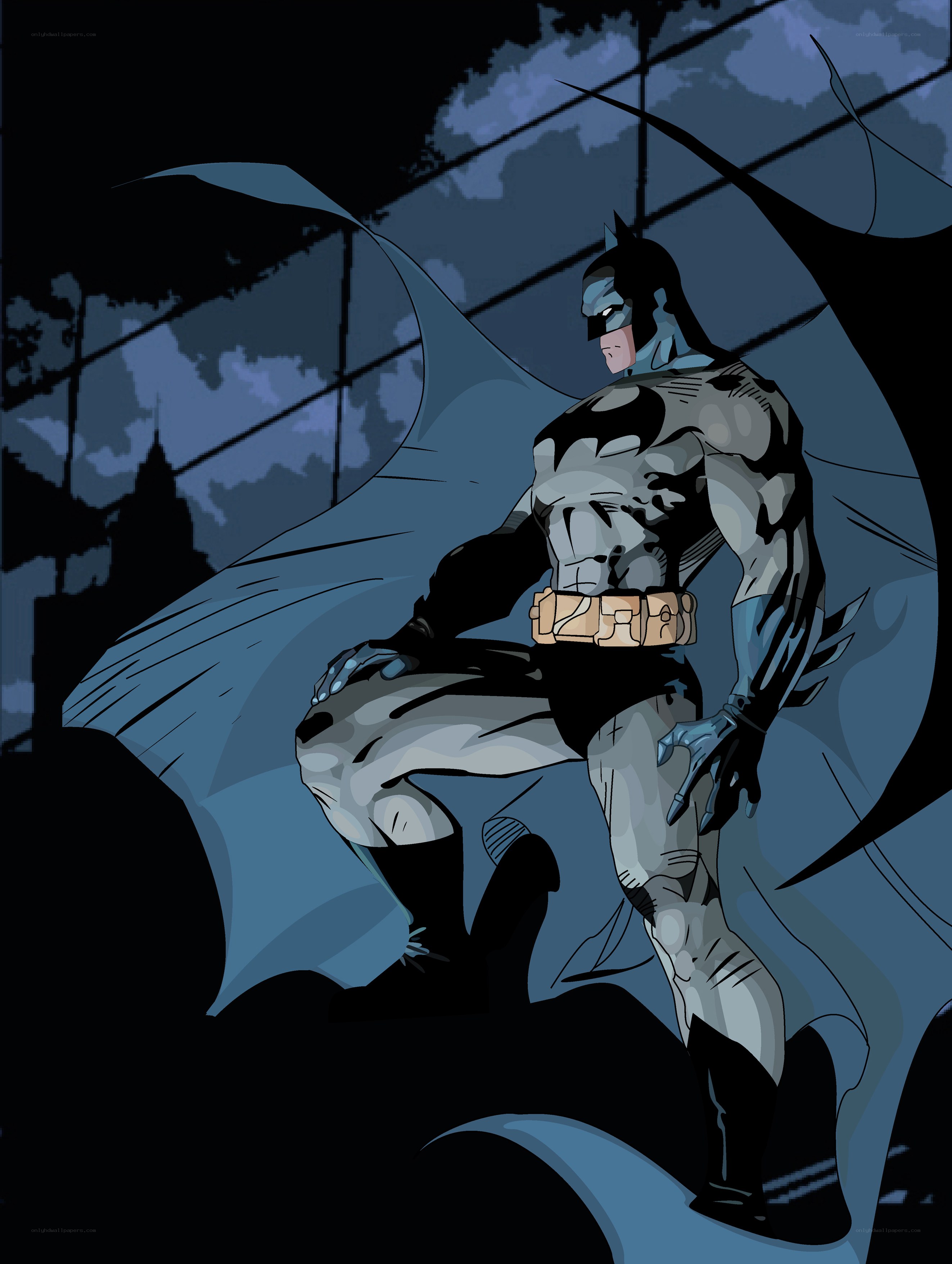 Batman stands on a rooftop