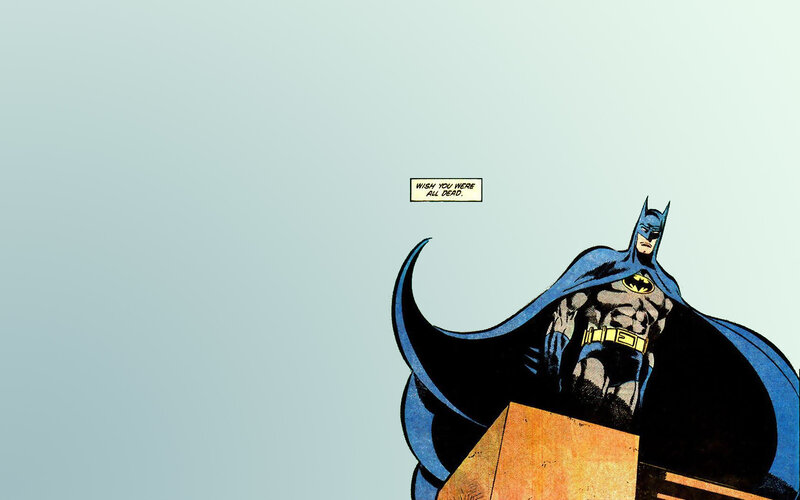 Batman stands on a rooftop