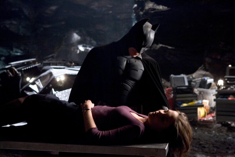 Batman with a woman on a table