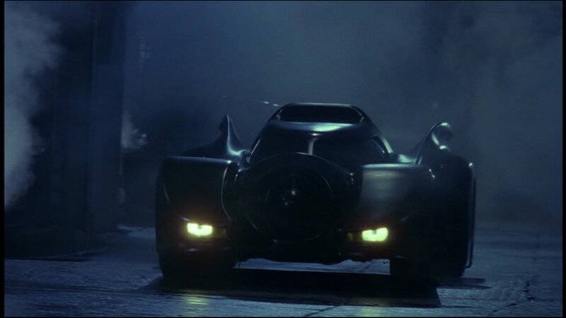 Batmobile in a smoky alley