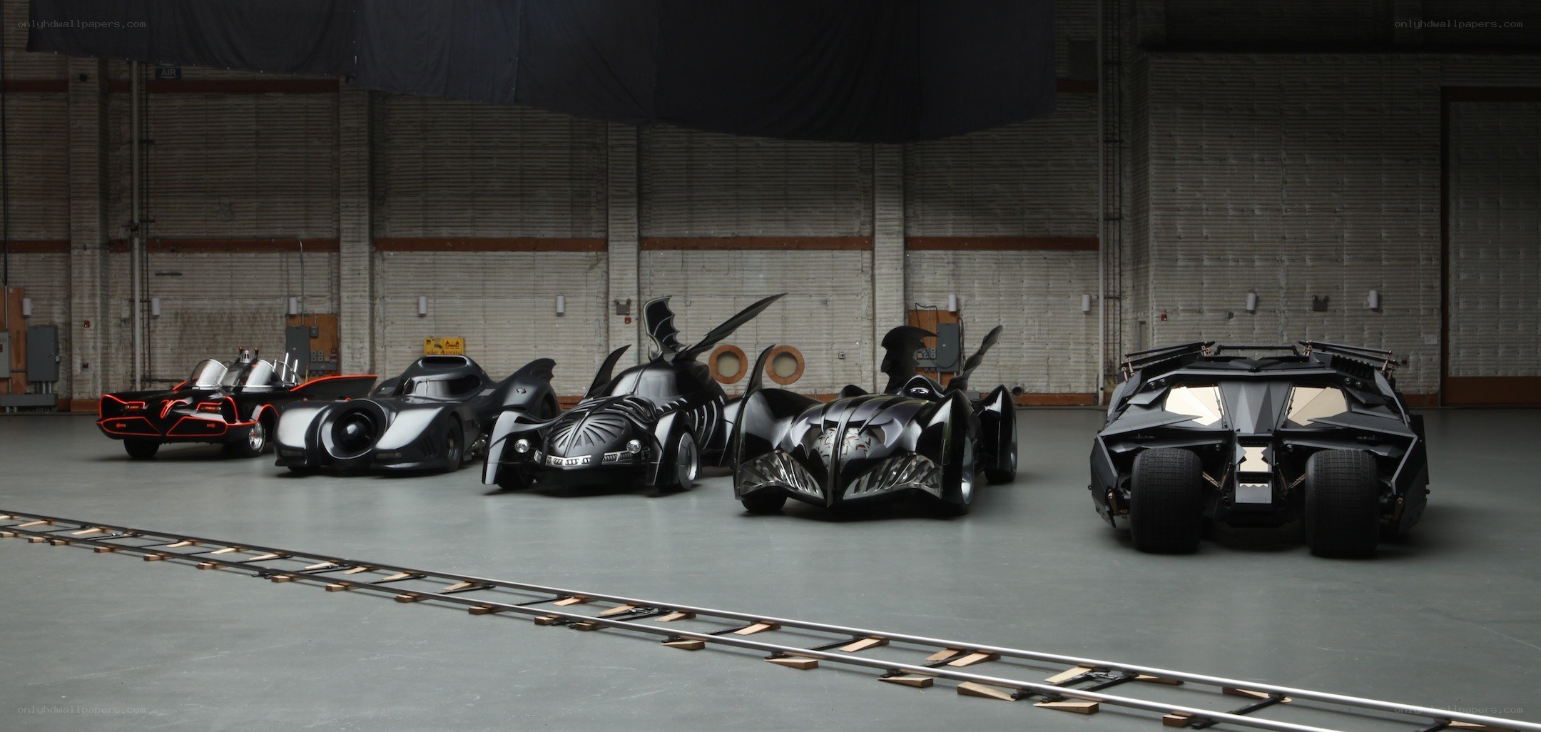 Batmobiles in a warehouse