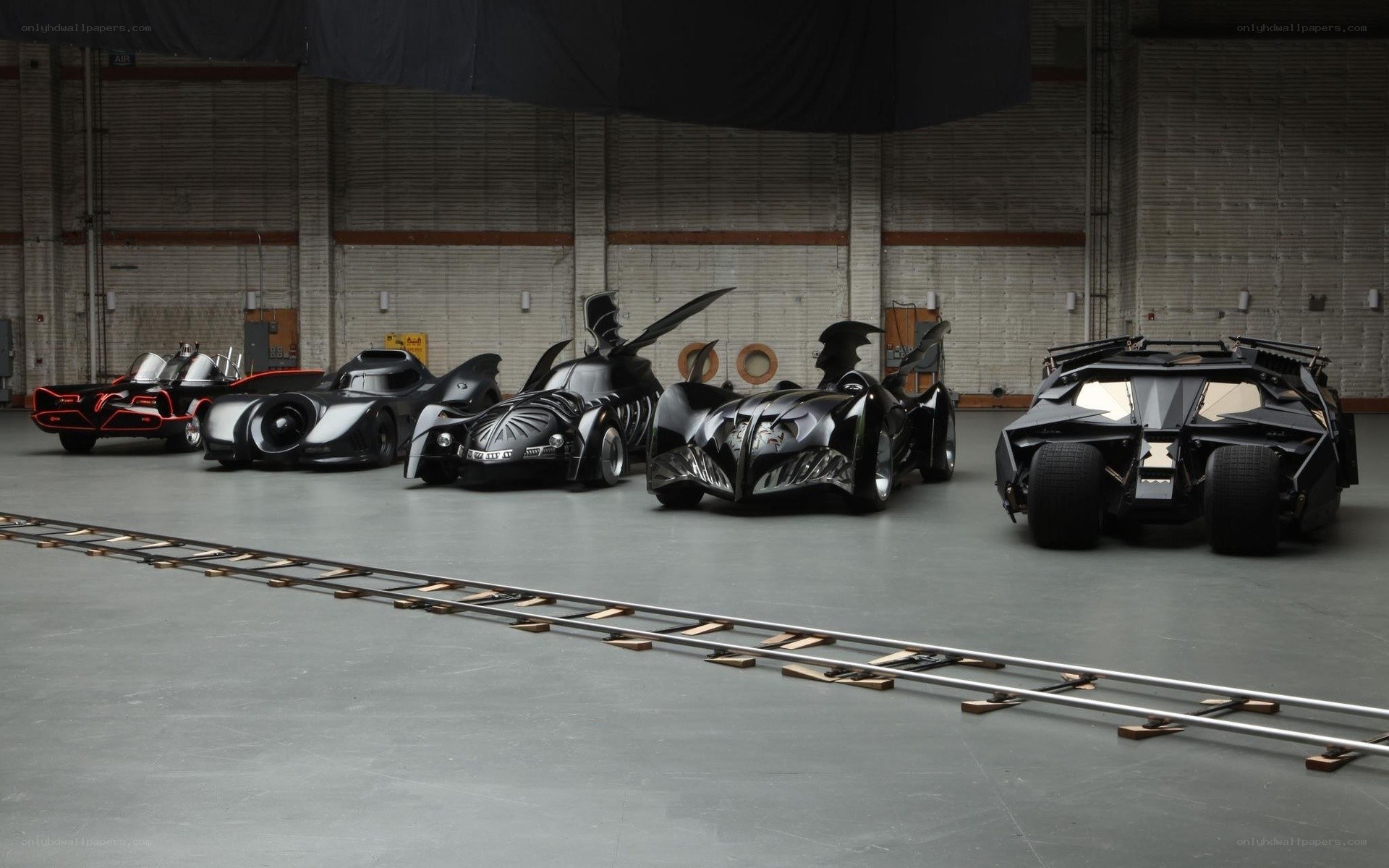 Batmobiles in a warehouse