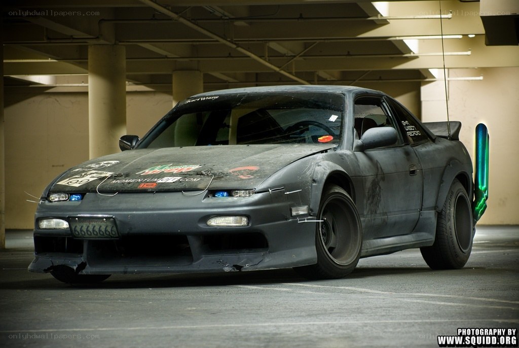 battle-worn drift car in garage