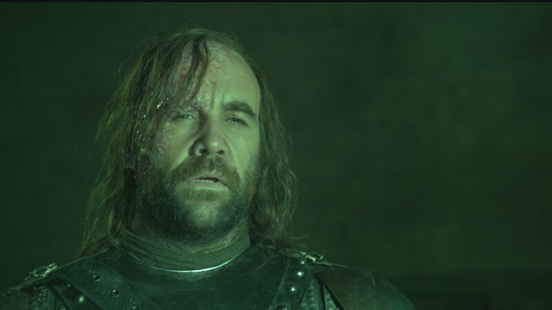 battle-worn warrior in green light