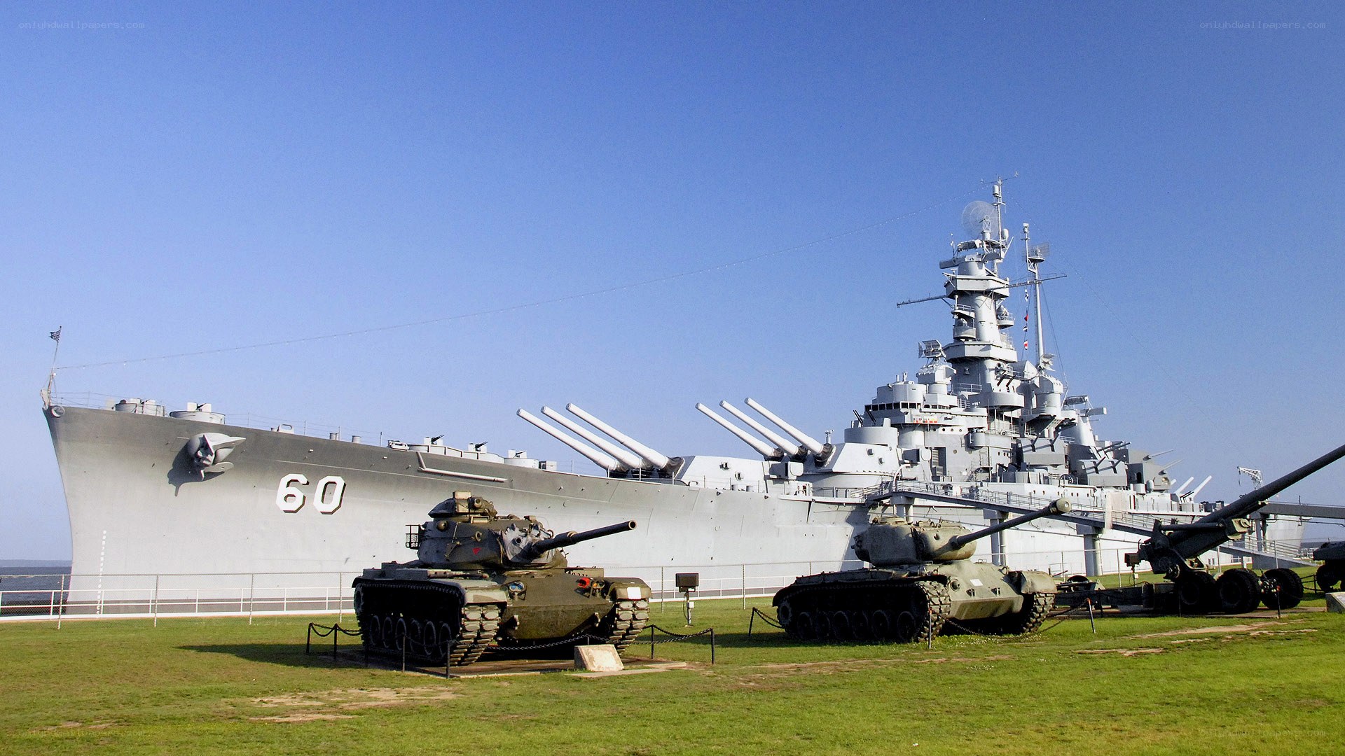 Battleship and tanks on display