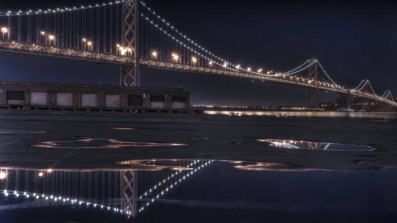 Bay Bridge at night with reflections