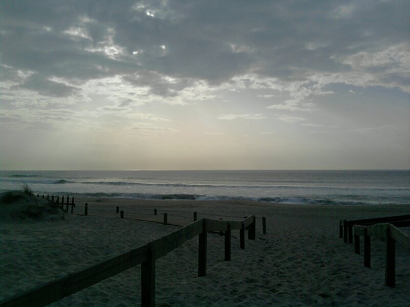 Beach at dawn with wooden walkway