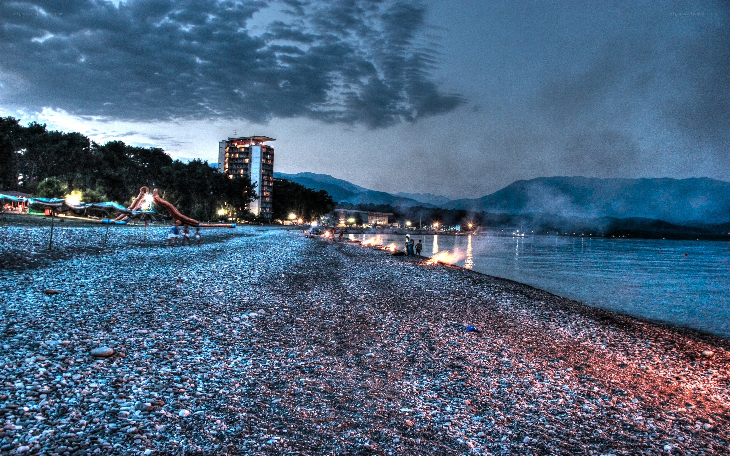 Beach at dusk with bonfire