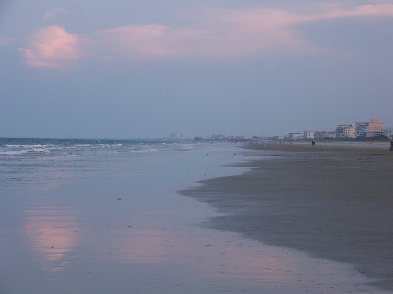 beach at dusk with buildings
