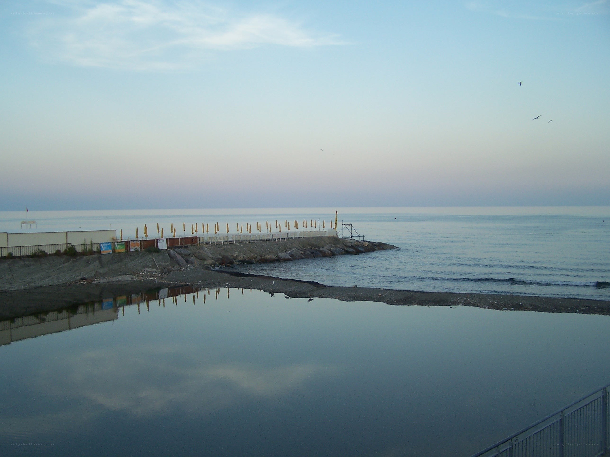 Beach at dusk with calm water