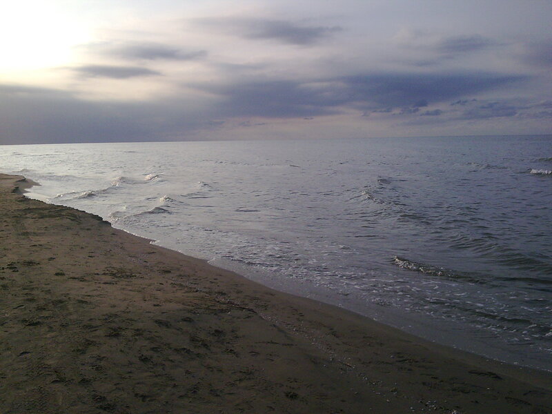 beach at dusk with calm waves