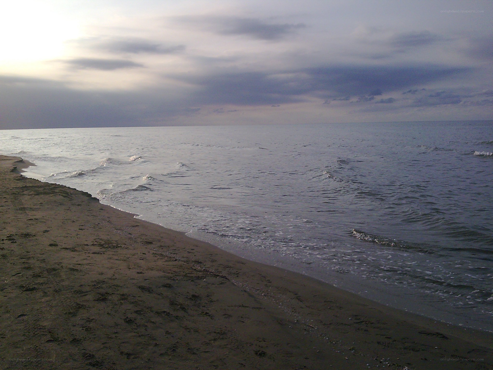 beach at dusk with calm waves