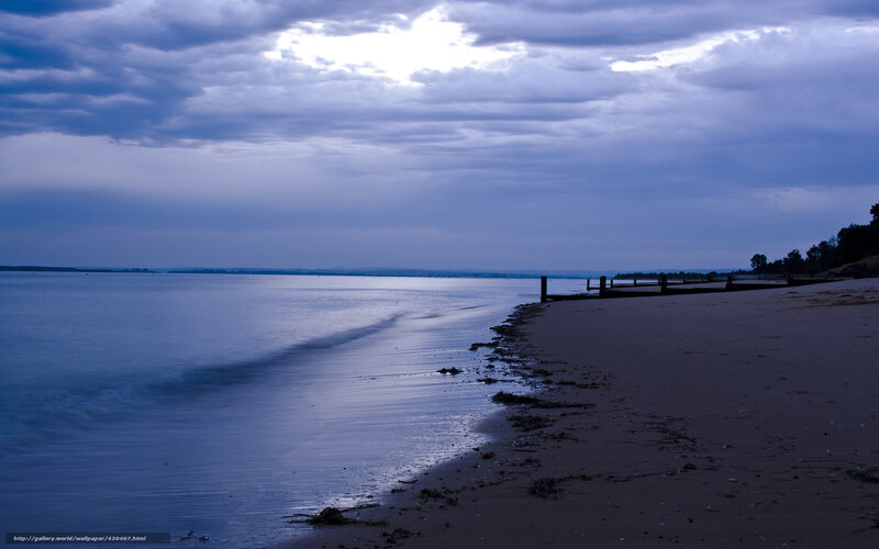 Beach at dusk with cloudy sky