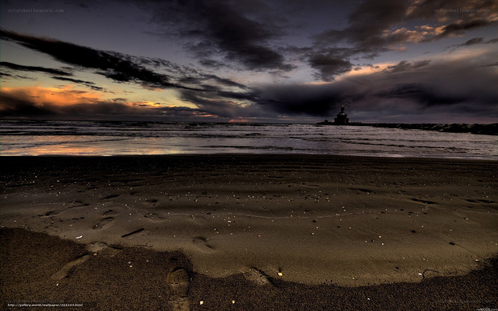 Beach at dusk with lighthouse