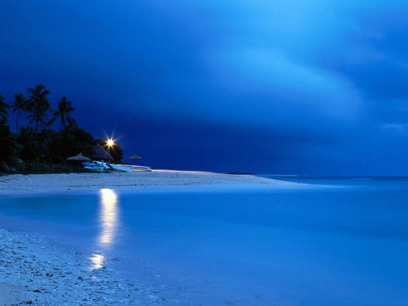 Beach at dusk with lights
