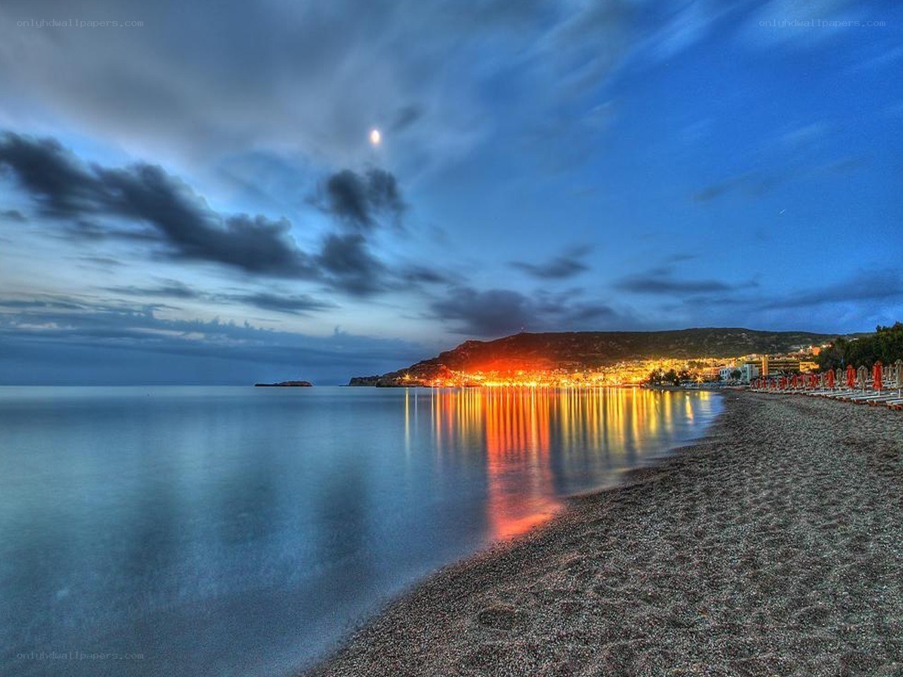 Beach at dusk with moonlit sky