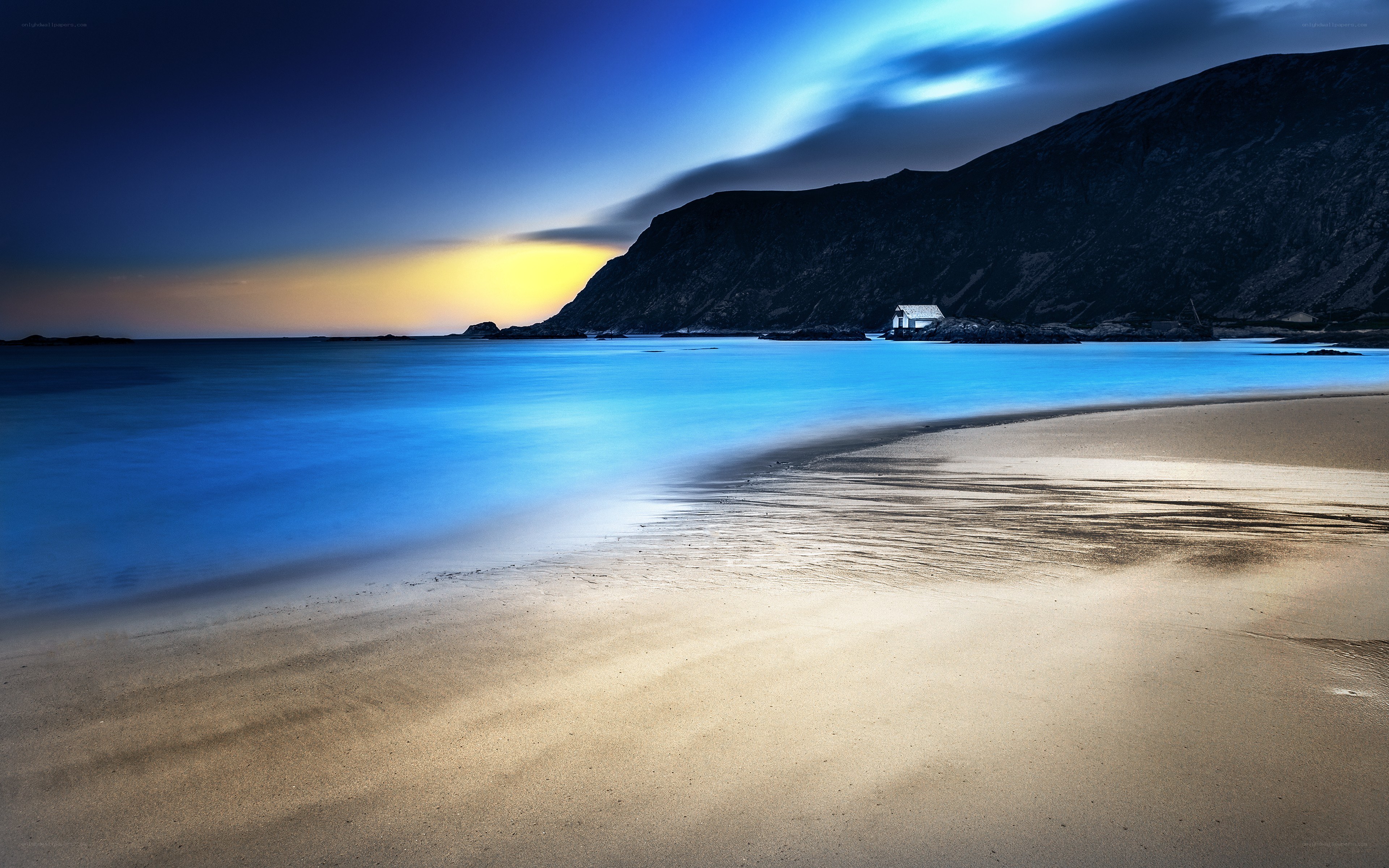 Beach at dusk with mountain