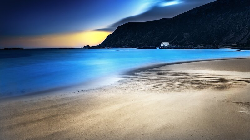 Beach at dusk with mountain