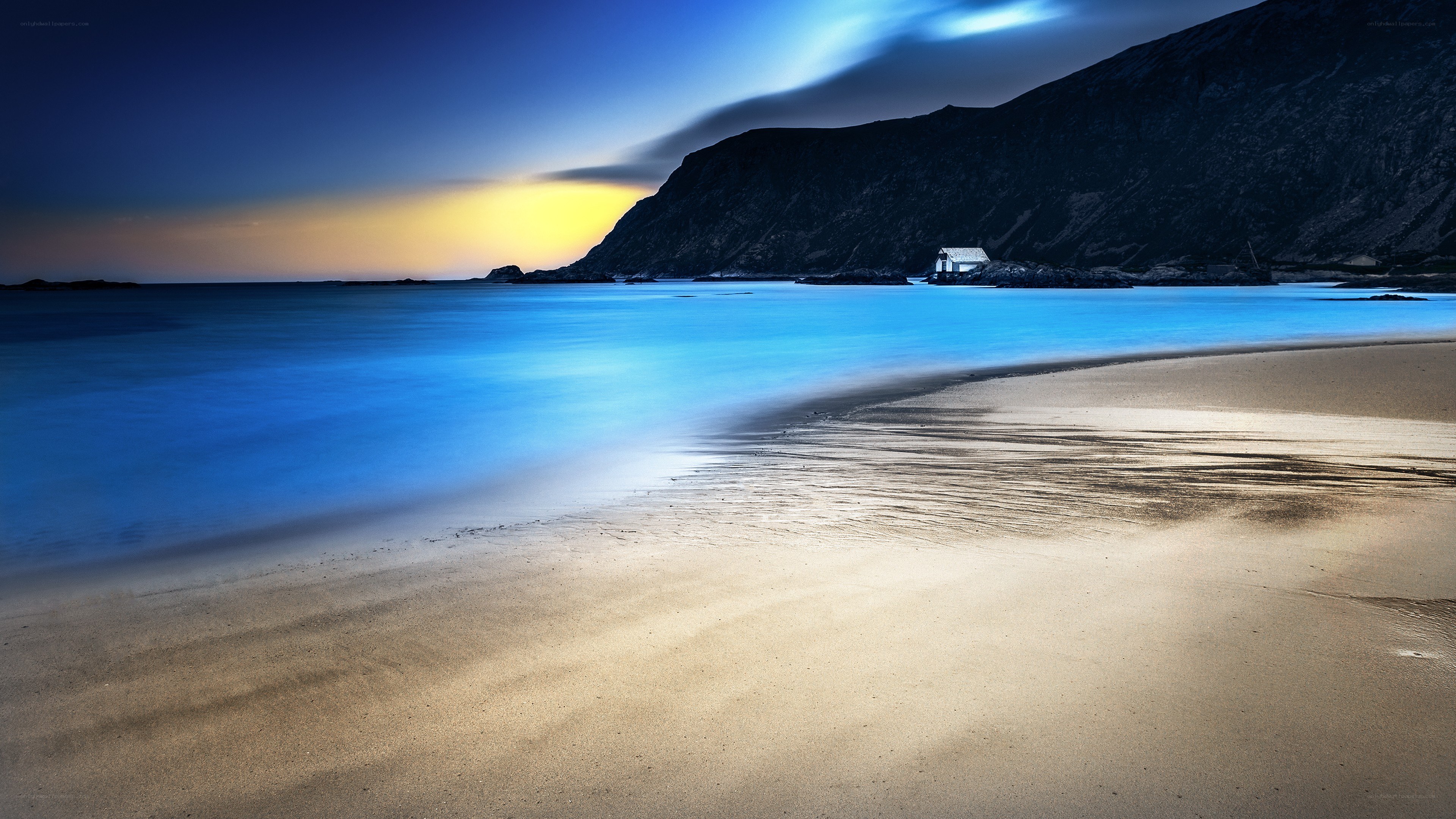 Beach at dusk with mountain
