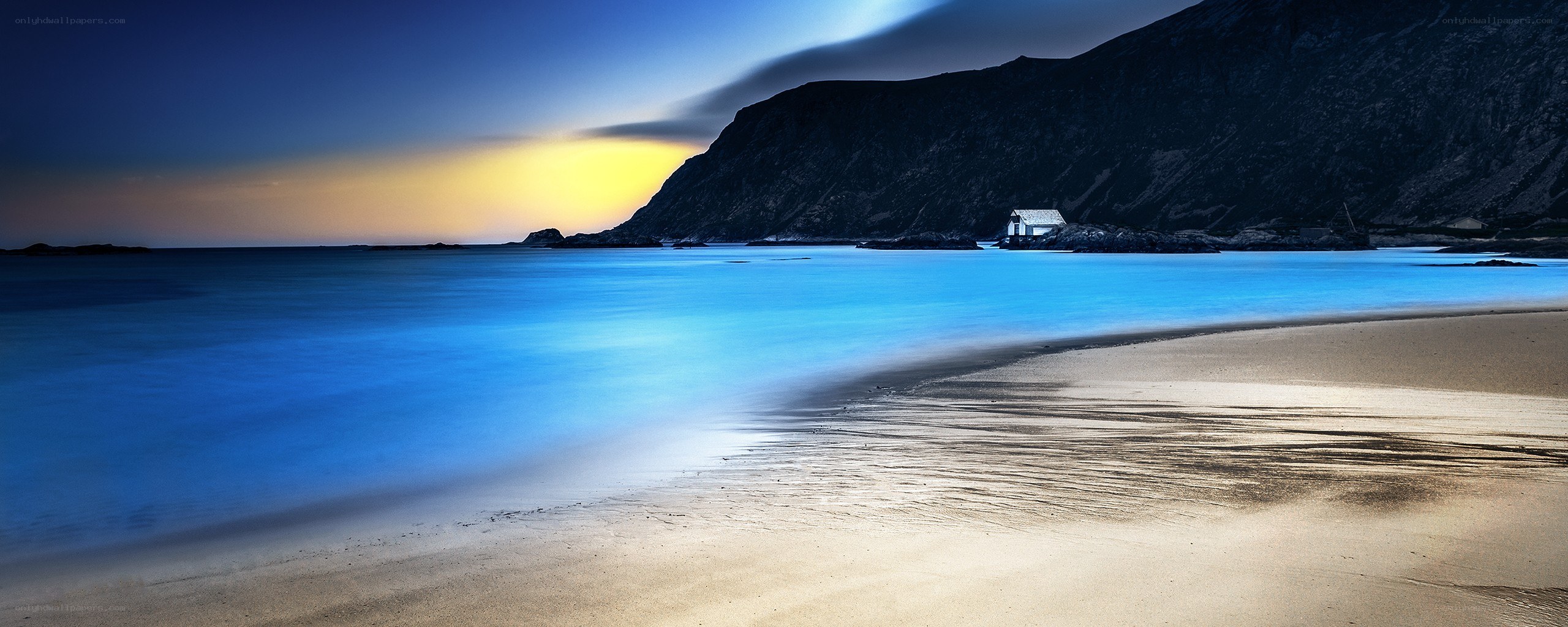 Beach at dusk with mountain