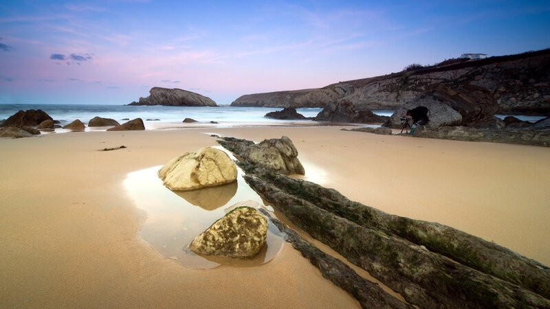 Beach at dusk with photographer