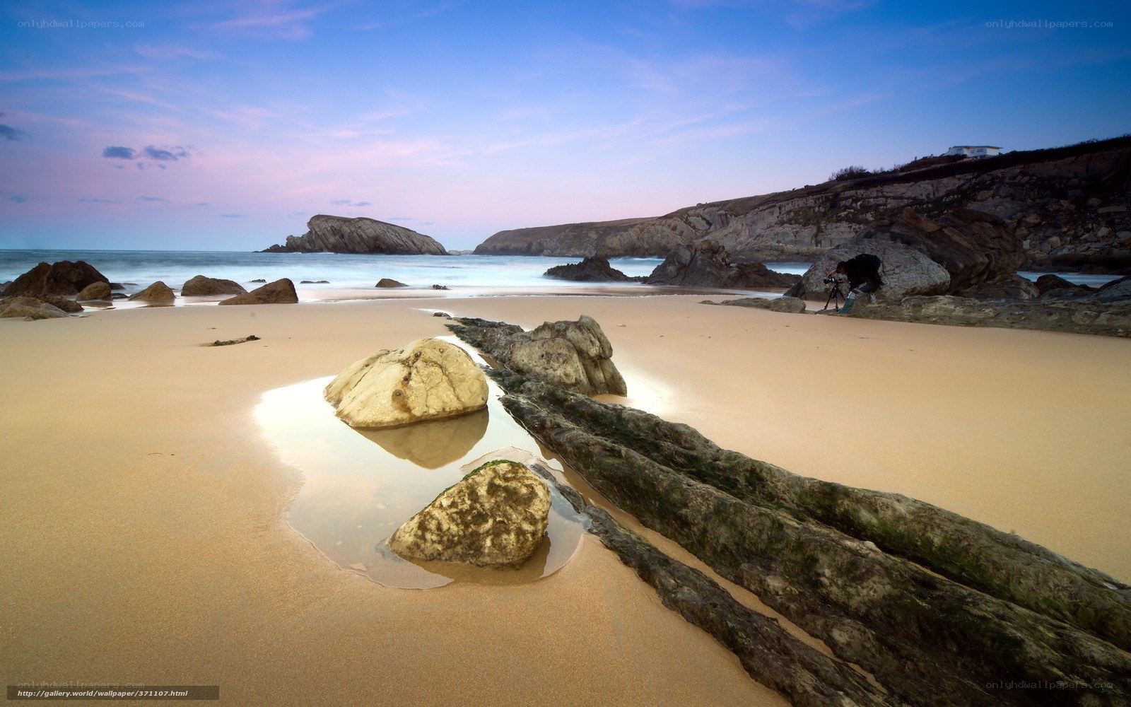 Beach at dusk with photographer