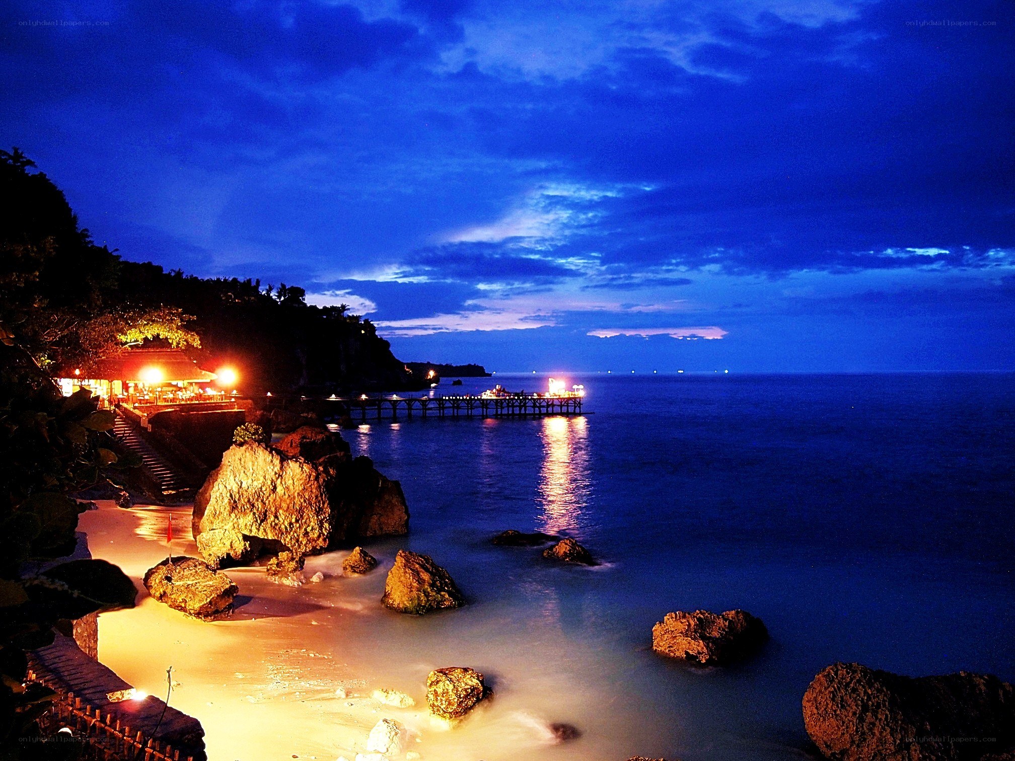Beach at dusk with pier