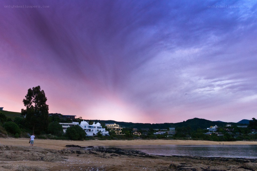 Beach at dusk with purple sky