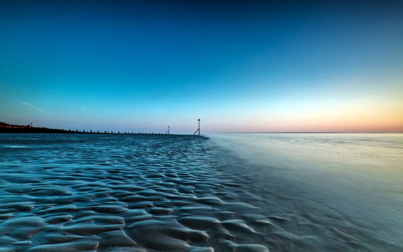 Beach at dusk with rippled sand