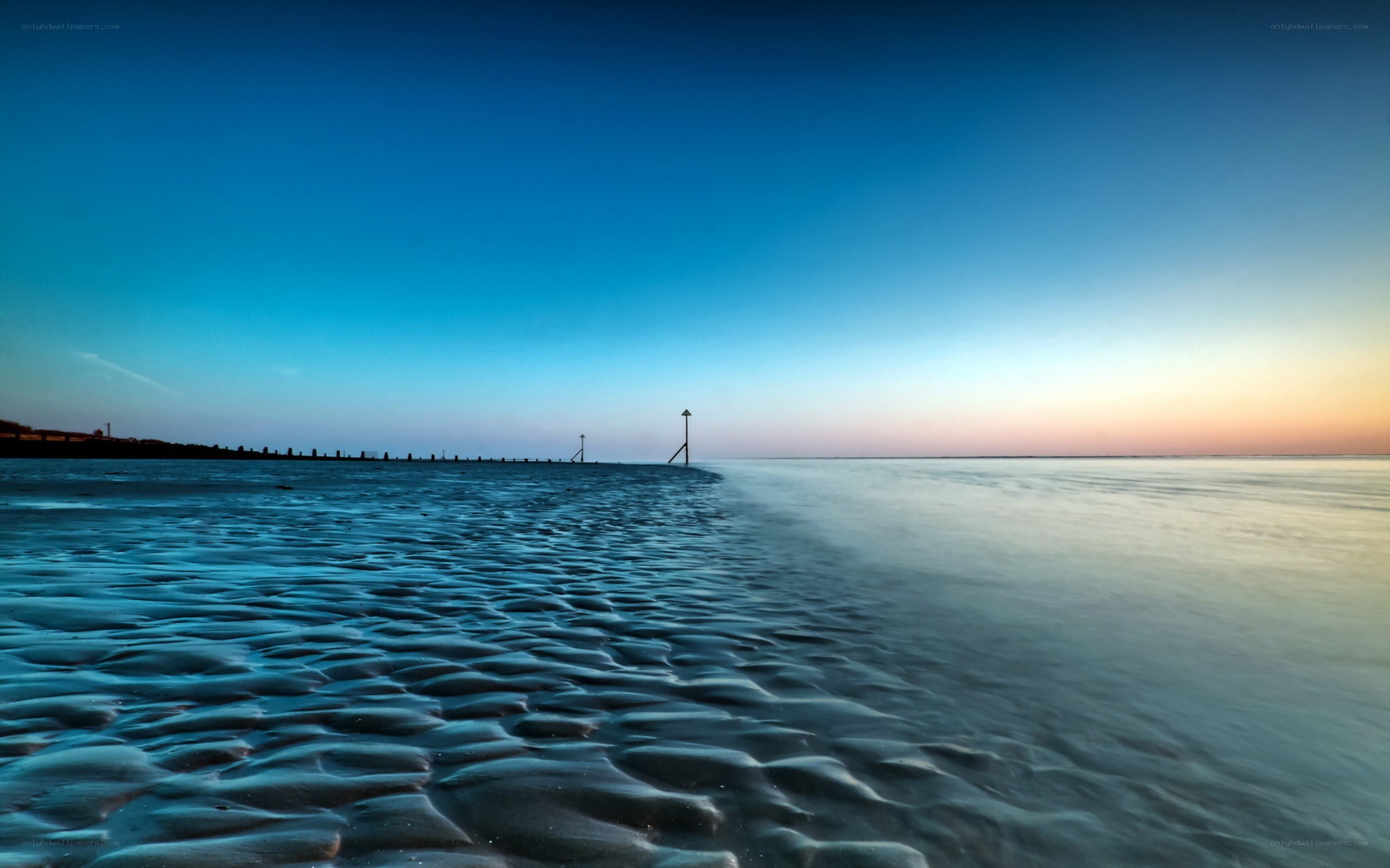 Beach at dusk with rippled sand