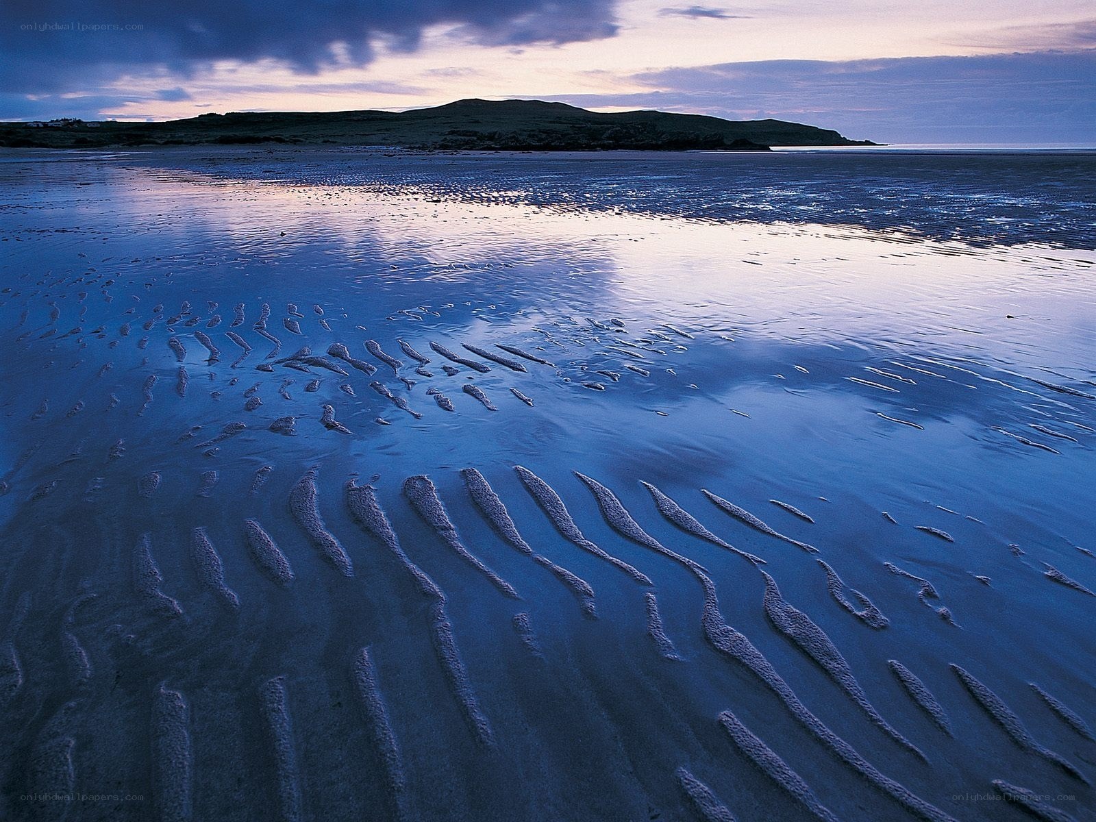 beach at dusk with rippled sand