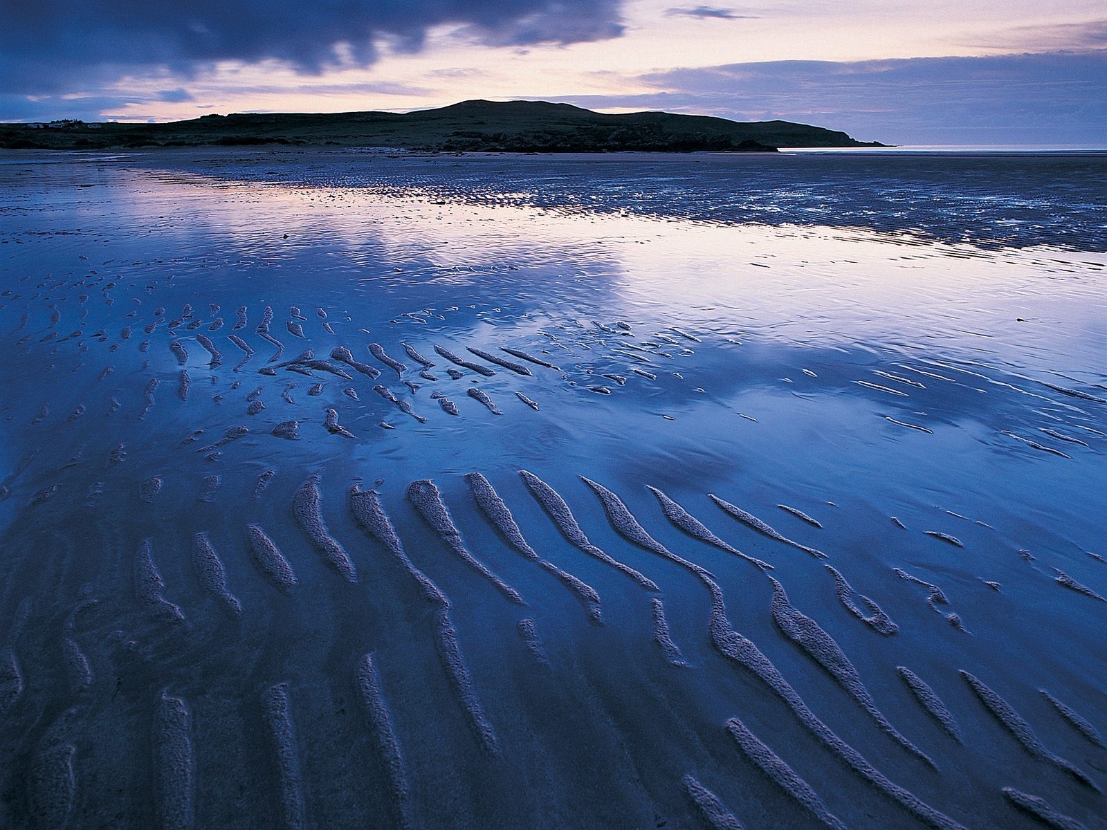 beach at dusk with rippled sand
