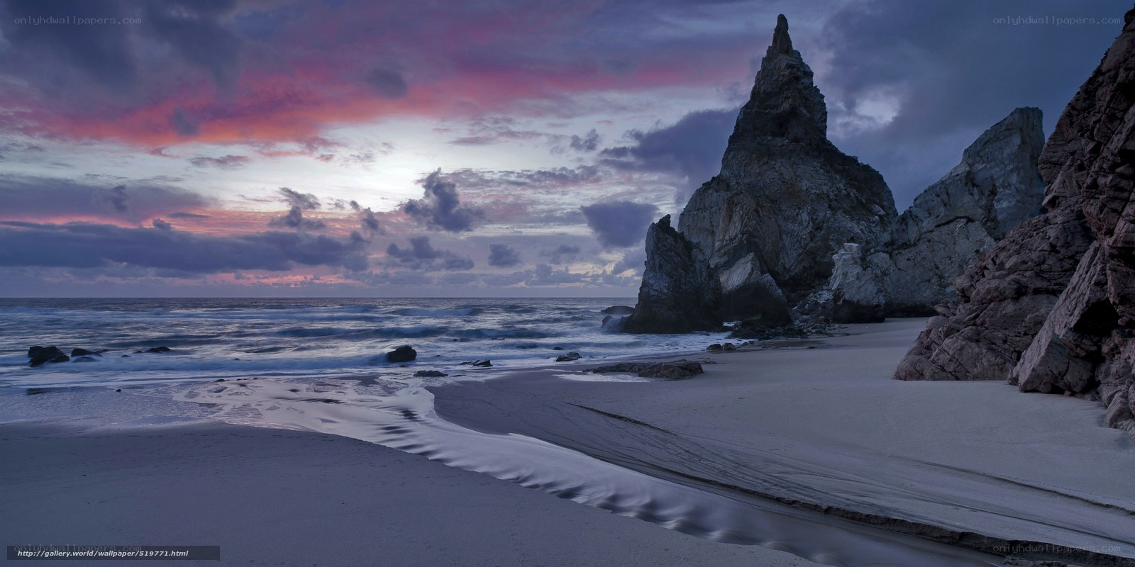 Beach at dusk with rock formations