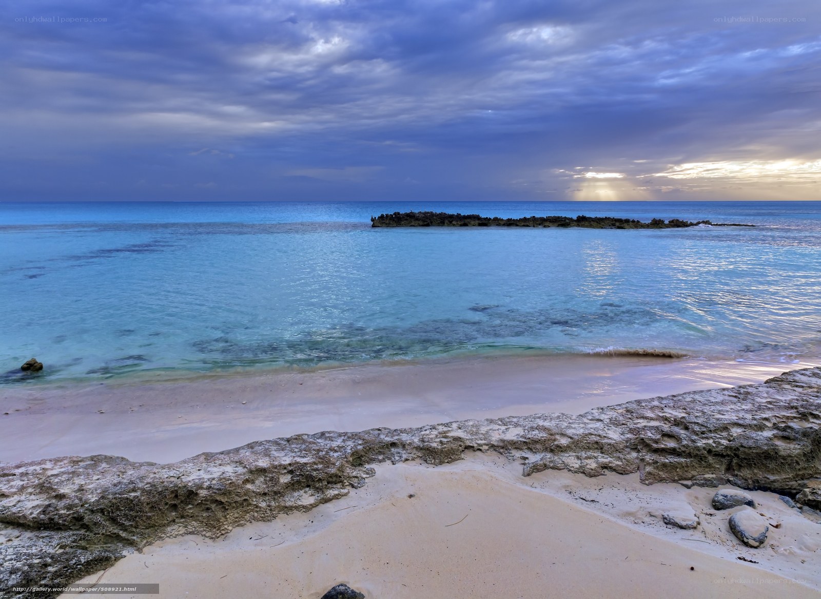 Beach at dusk with rocky outcrop