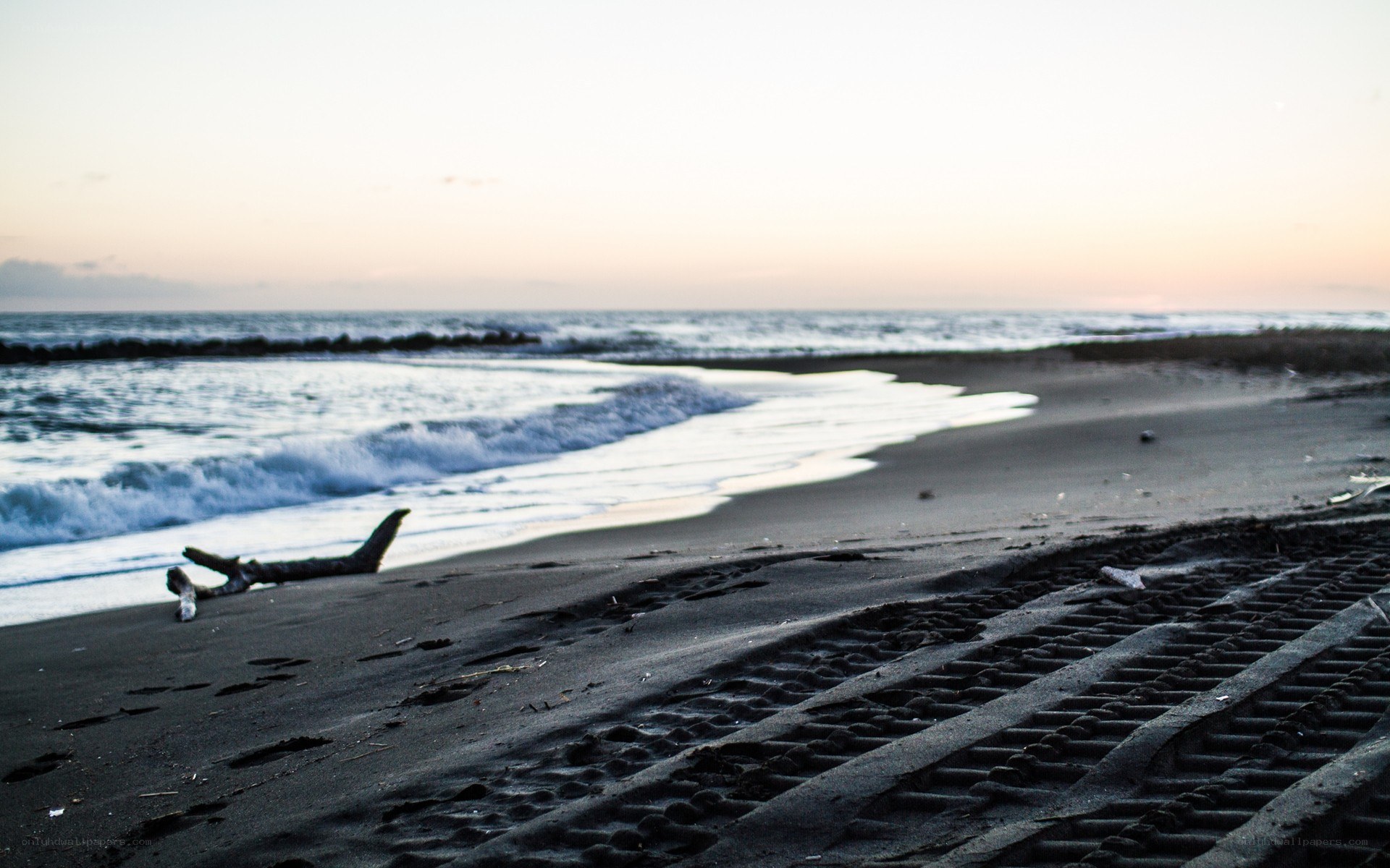 beach at dusk with tire tracks
