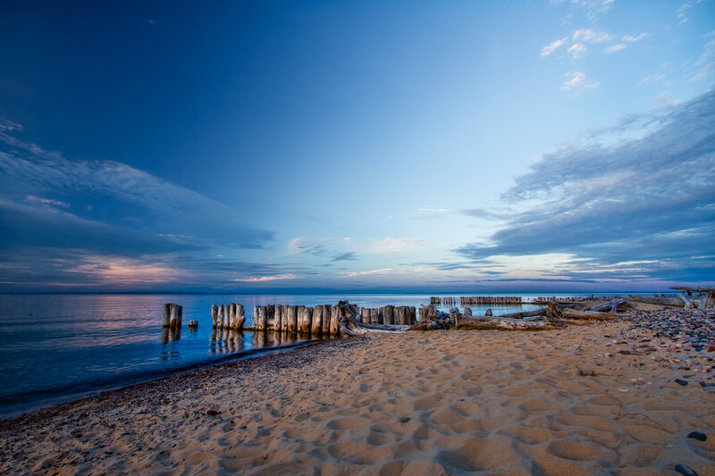 Beach at dusk with wooden posts