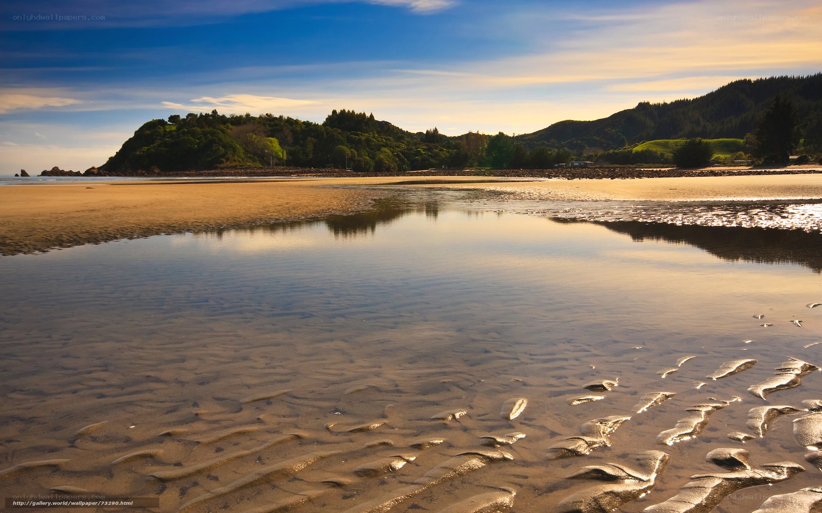 Beach at low tide with hills