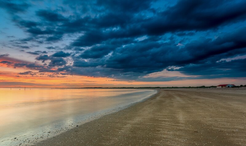 Beach at Sunset — Blue, Dramatic, Photograph, Clouds, Ocean, Building