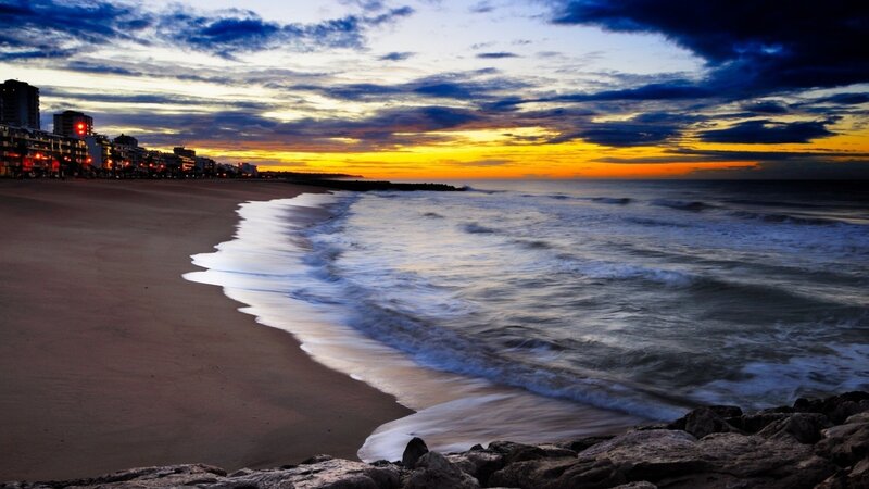 Beach at Sunset — Blue, Dramatic, Photograph, Ocean, Buildings