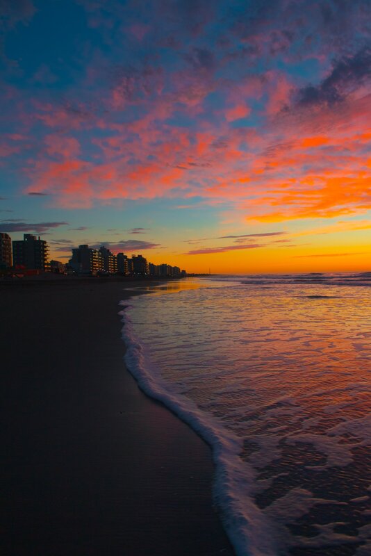 Beach at Sunset — Orange, Dramatic, Photograph, Sky, Ocean, Buildings