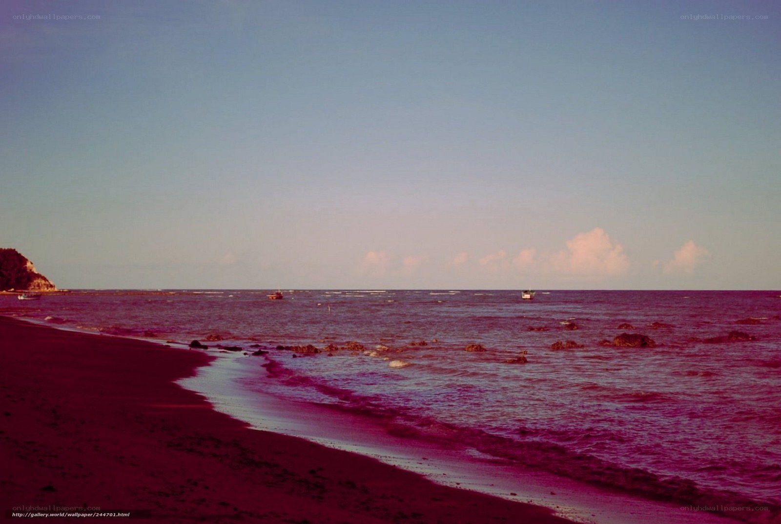 beach at sunset with boats