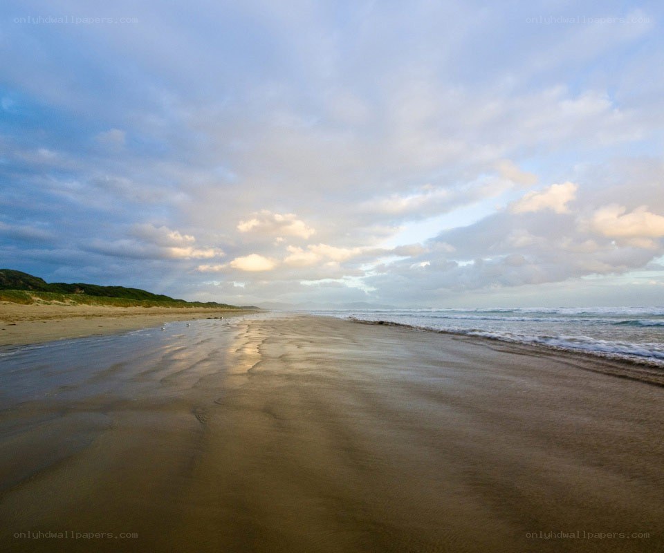 beach at sunset with clouds