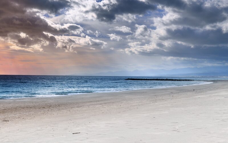 Beach at sunset with dramatic clouds