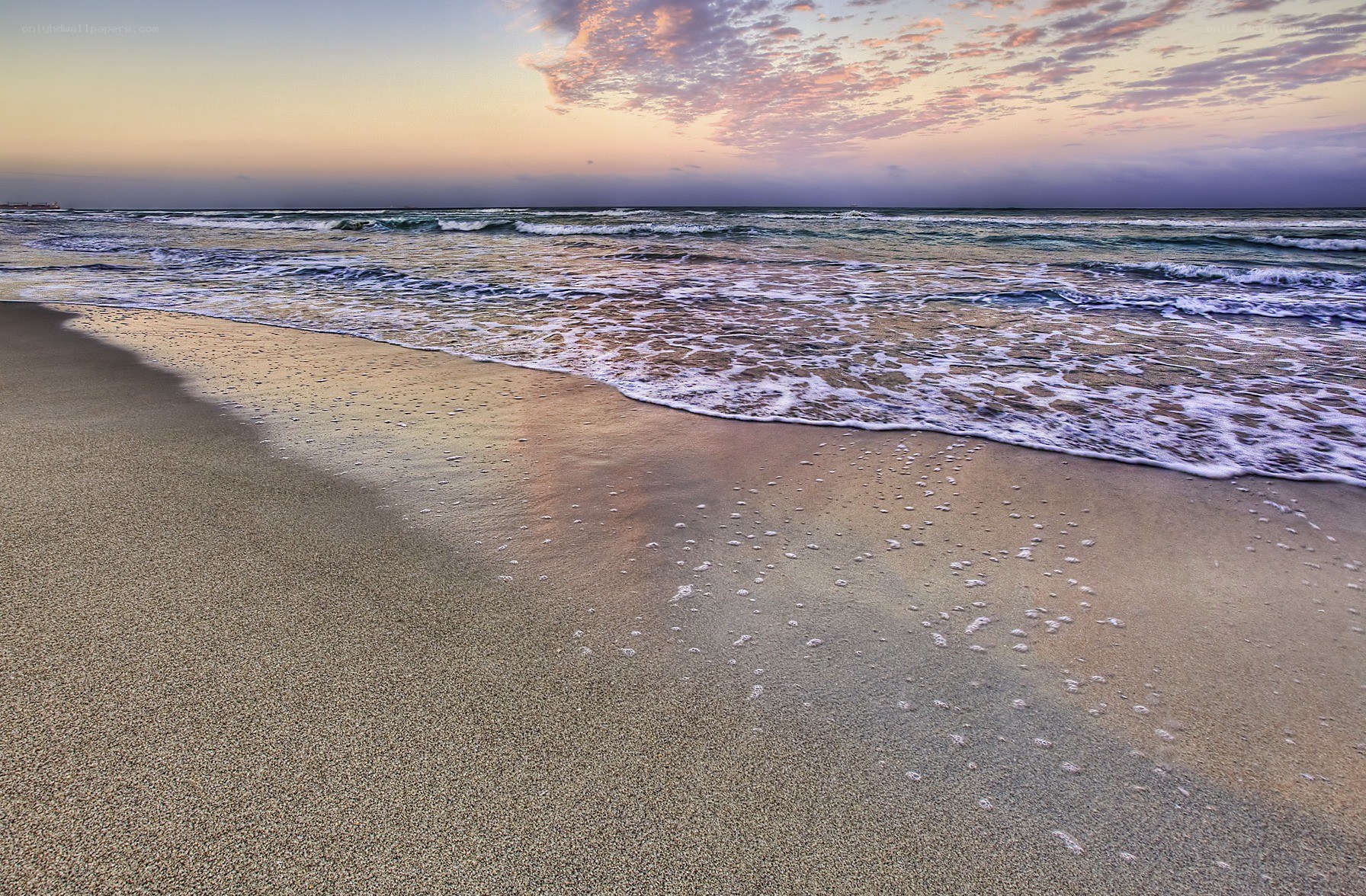 Beach at sunset with gentle waves