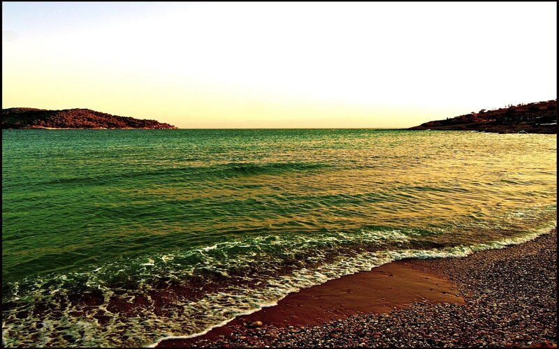 beach at sunset with green water