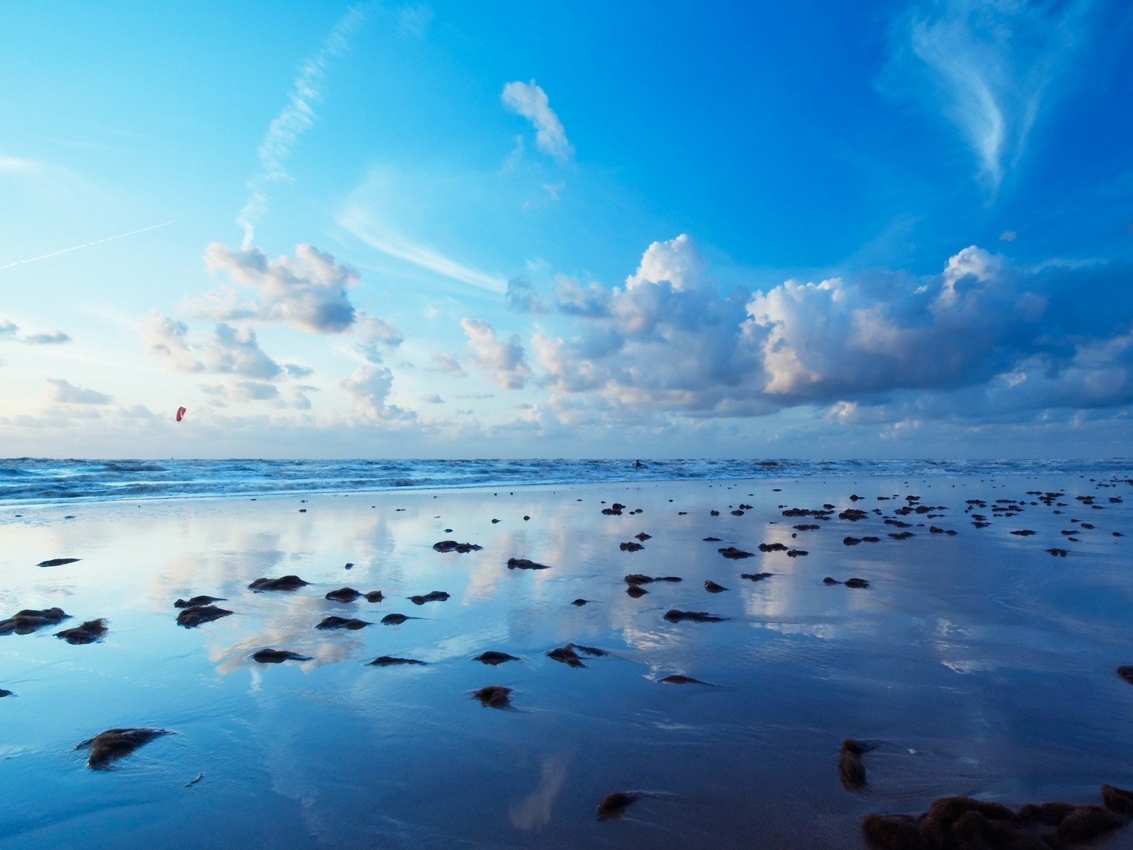 Beach at sunset with kitesurfer