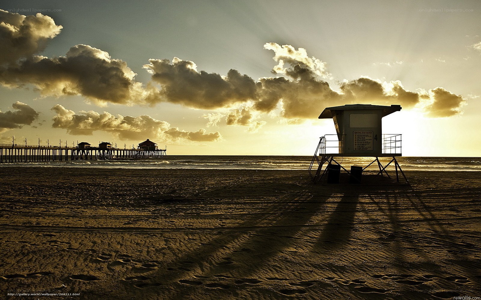Beach at sunset with lifeguard tower