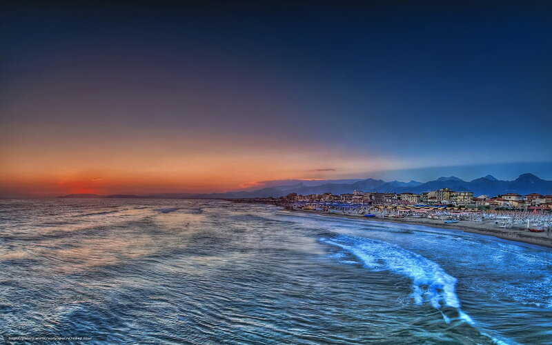 Beach at sunset with mountains