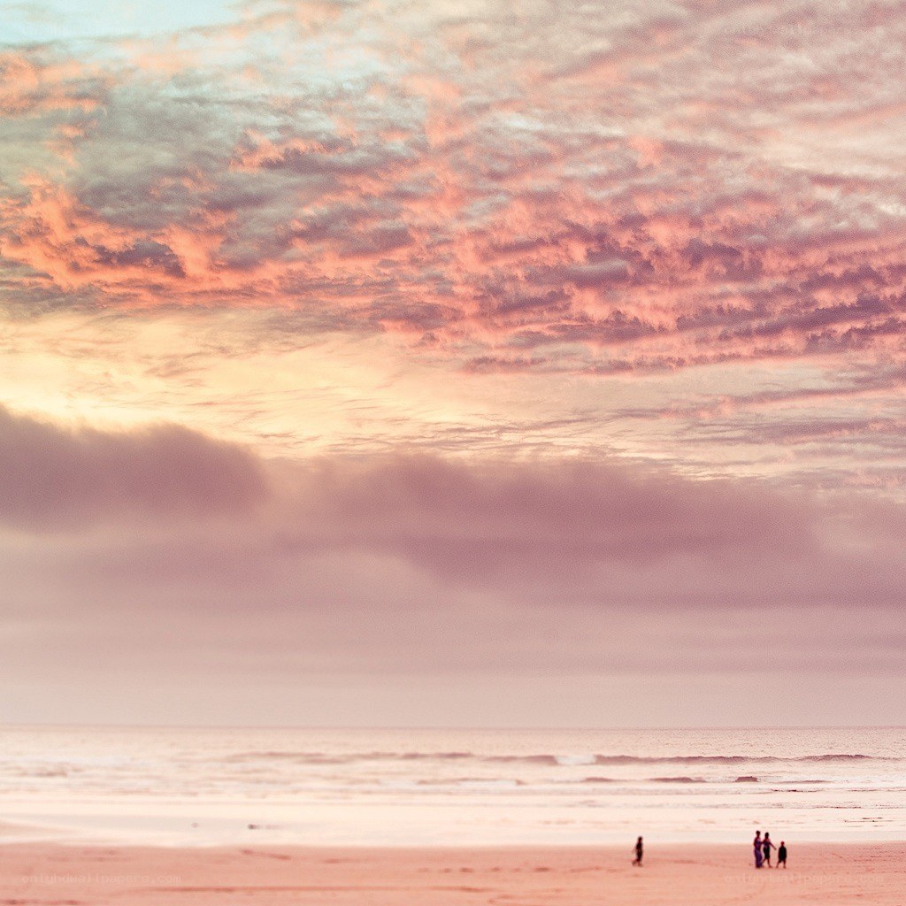 Beach at sunset with people