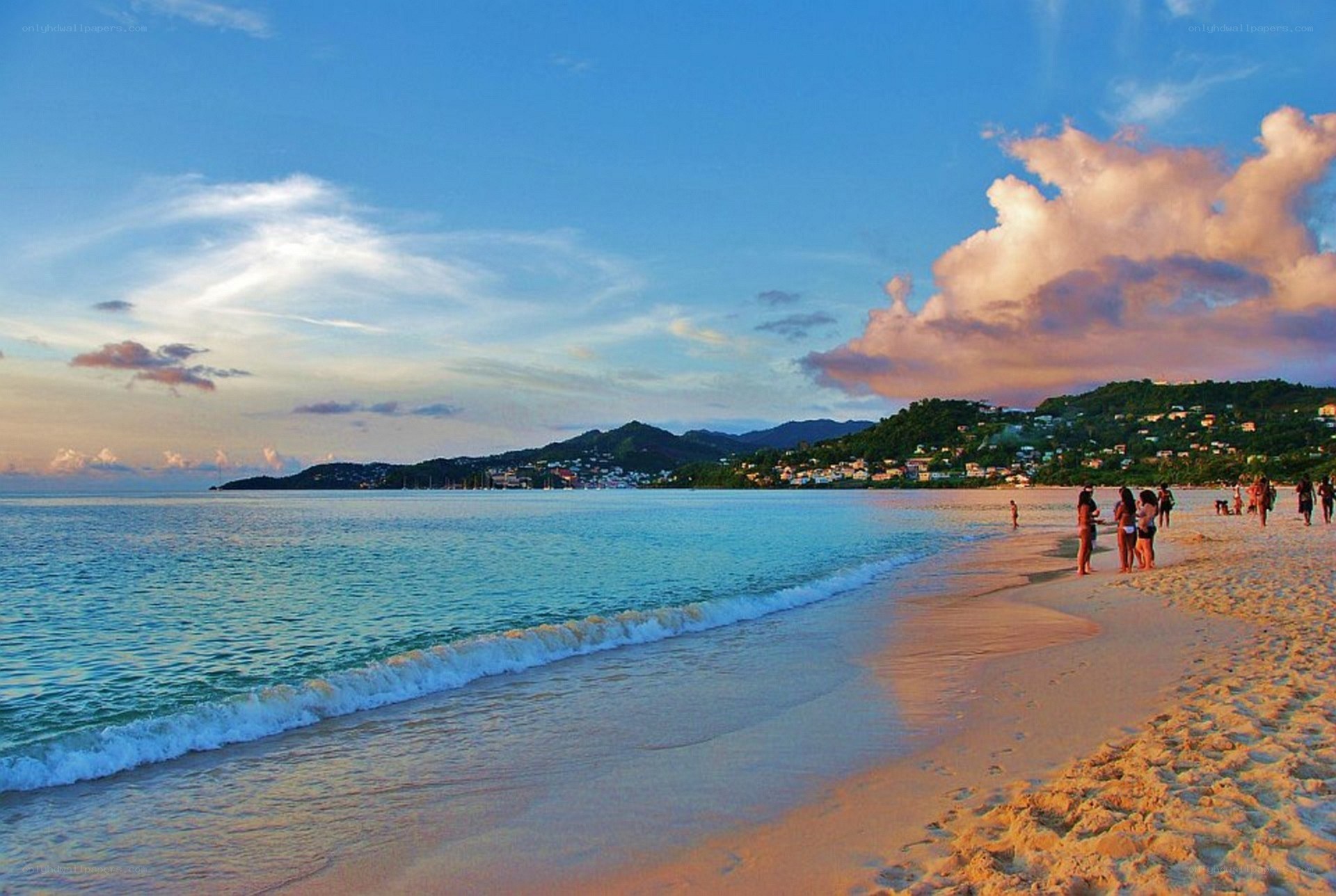 Beach at sunset with people